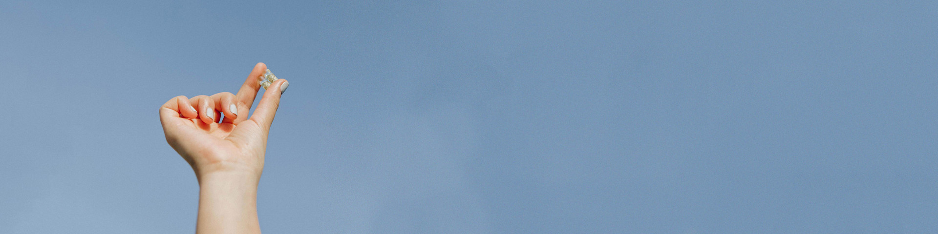 Two multivitamins in hand.